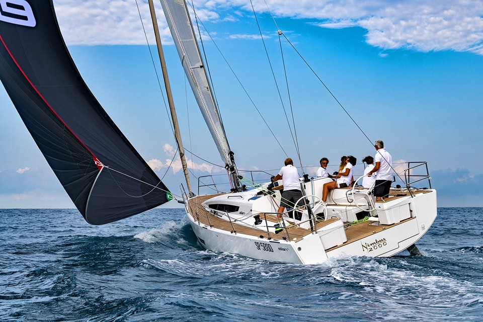 Crew working a sailing yacht under gennaker